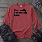 Currently Becoming Lore Long Sleeve T-Shirt